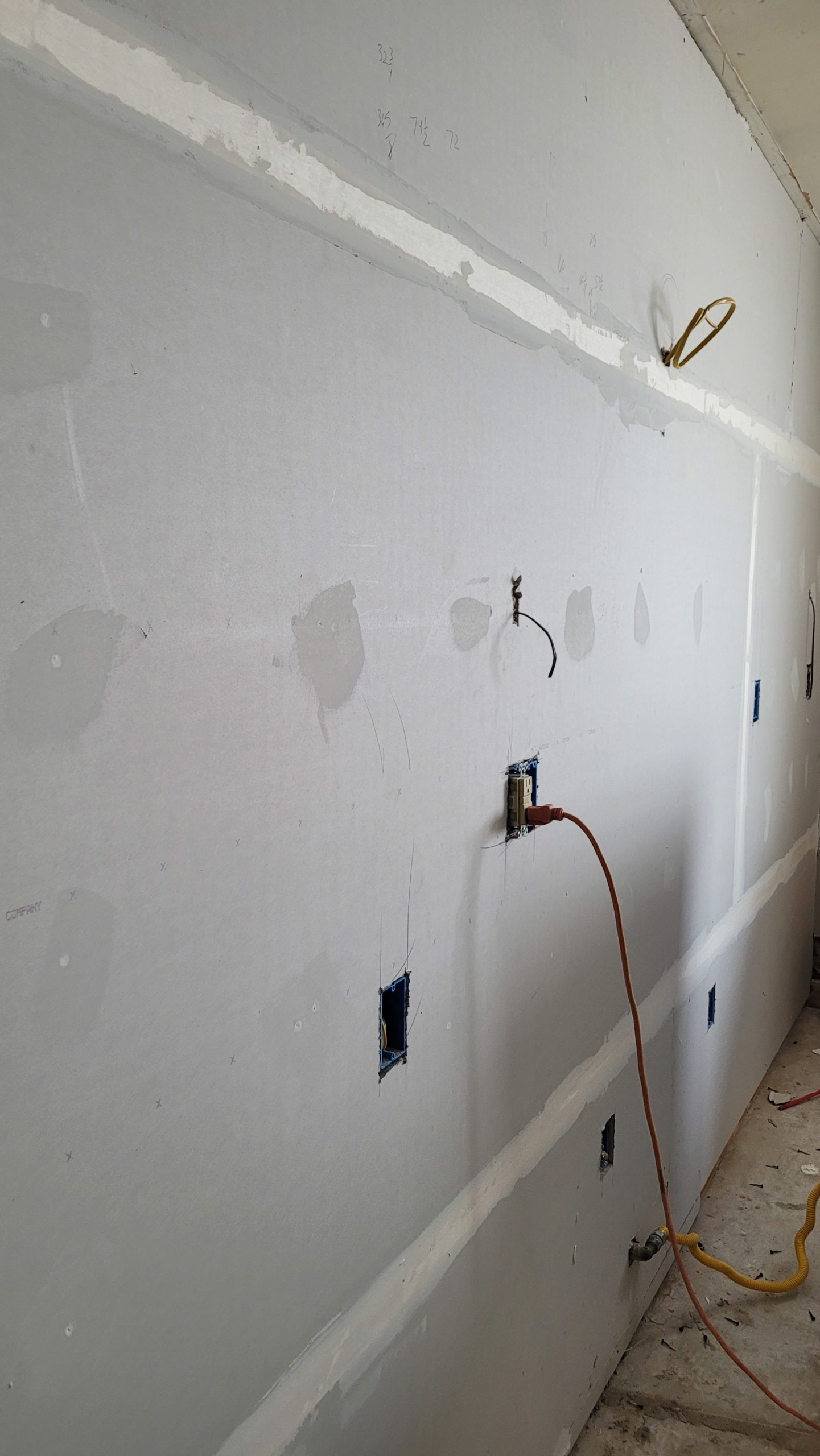 partially finished drywall- taped with the first layer of drywall mud.